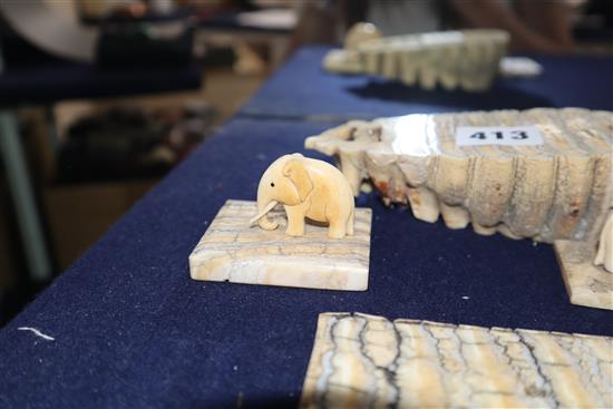 Two ivory elephant figures with elephant tooth stands and two elephant tooth specimens, early 20th century,